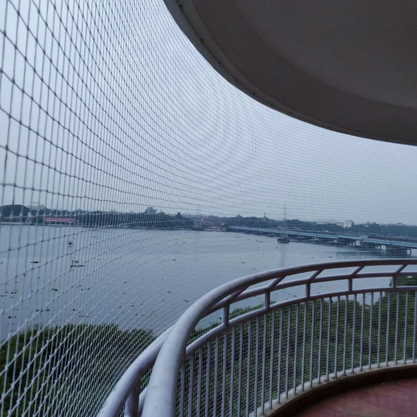 Bird netting installation on a balcony overlooking the backwaters