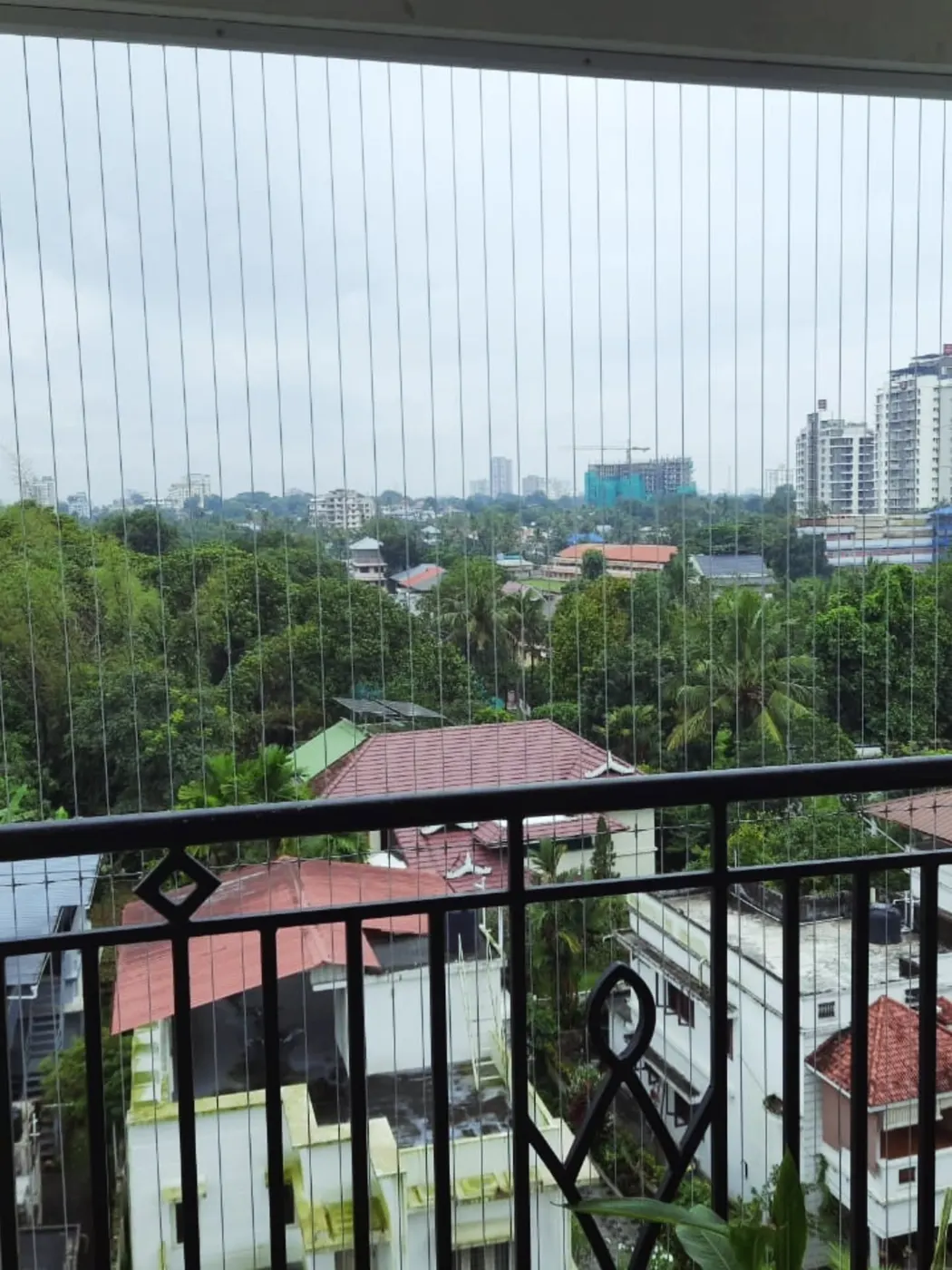 Invisible stainless-steel grill installed on a rooftop balcony, Kerala