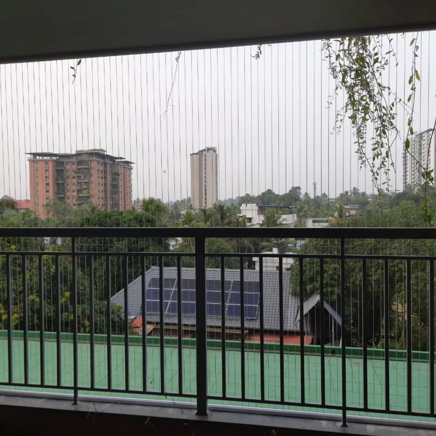 Invisible grill installation on a high-rise balcony